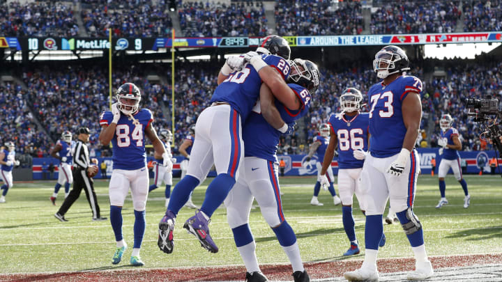 EAST RUTHERFORD, NEW JERSEY – DECEMBER 04: (NEW YORK DAILIES OUT) Saquon Barkley #26 of the New York Giants celebrates his touchdown against the Washington Commanders with teammate Mark Glowinski #64 at MetLife Stadium on December 04, 2022 in East Rutherford, New Jersey. The game ended in a 20-20 tie. (Photo by Jim McIsaac/Getty Images)