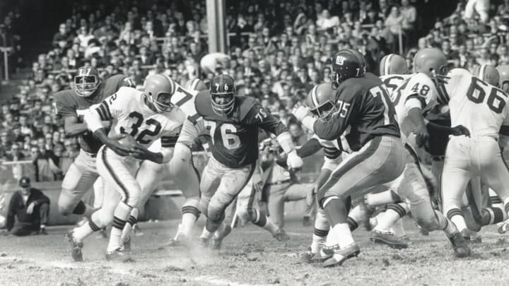 BRONX, NY – OCTOBER 24: Jim Brown #32 of the Cleveland Browns carries the ball against Rosey Davis #77, John LoVetere #76 and Jim Katcavage #75 of the New York Giants during the game at Yankee Stadium on October 24, 1965 in the Bronx, New York. (Photo by Robert Riger/Getty Images)