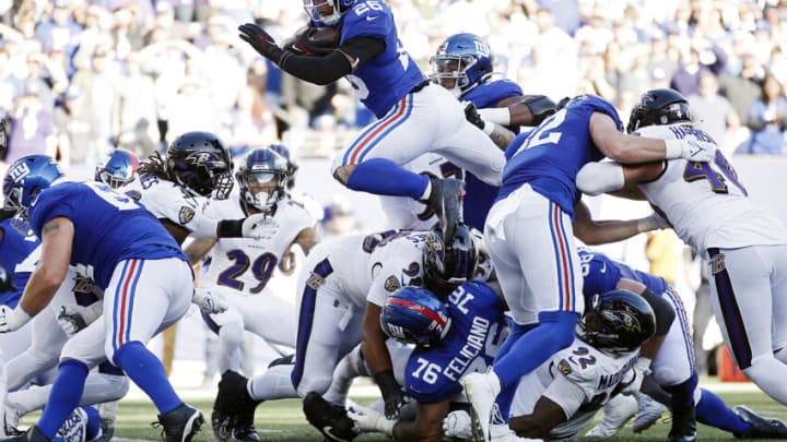 EAST RUTHERFORD, NEW JERSEY - OCTOBER 16: Saquon Barkley #26 of the New York Giants scores a touchdown during the fourth quarter against the Baltimore Ravens at MetLife Stadium on October 16, 2022 in East Rutherford, New Jersey. (Photo by Sarah Stier/Getty Images)