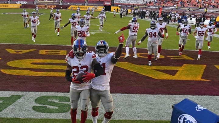 Nov 8, 2020; Landover, Maryland, USA; New York Giants cornerback Logan Ryan (23) celebrates with safety Jabrill Peppers (21) after an interception against the Washington Football Team during the second half at FedExField. Mandatory Credit: Brad Mills-USA TODAY Sports