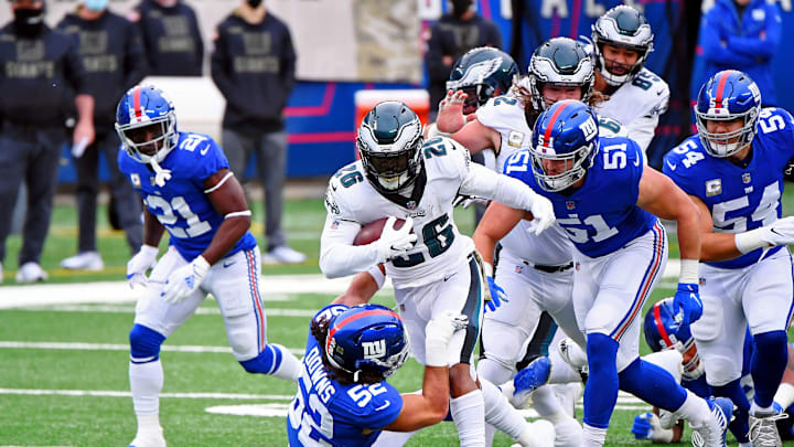 Nov 15, 2020; East Rutherford, New Jersey, USA; Philadelphia Eagles running back Miles Sanders (26) runs with the ball while New York Giants linebacker Devante Downs (52) attempts a tackle during the first quarter at MetLife Stadium. Mandatory Credit: Robert Deutsch-USA TODAY Sports