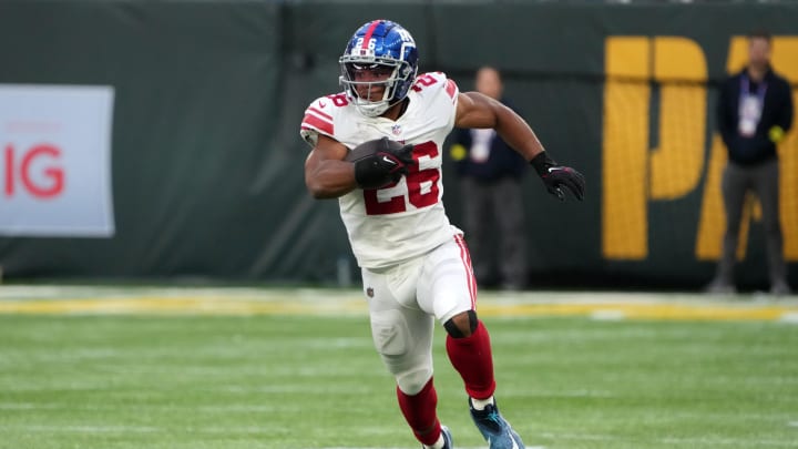 Oct 9, 2022; London, United Kingdom; New York Giants running back Saquon Barkley (26) carries the ball in the fourth quarter against the Green Bay Packers during an NFL International Series game at Tottenham Hotspur Stadium. Mandatory Credit: Kirby Lee-USA TODAY Sports