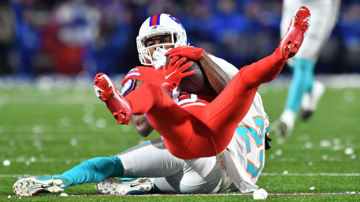 Dec 17, 2022; Orchard Park, New York, USA; Buffalo Bills wide receiver Isaiah McKenzie (6) is tackled by Miami Dolphins cornerback Keion Crossen (27) after a catch in the second quarter at Highmark Stadium. Mandatory Credit: Mark Konezny-USA TODAY Sports