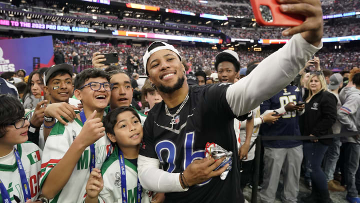 Feb 5, 2023; Paradise, Nevada, USA; NFC running back Saquon Barkley of the New York Giants (26) takes a selfie with NFL Flag team Mexico at the 2023 Pro Bowl at Allegiant Stadium. Mandatory Credit: Lucas Peltier-USA TODAY Sports