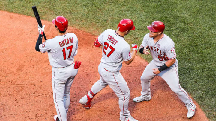 BOSTON, MA - AUGUST 10: Mike Trout #27 high fives Kole Calhoun #56 of the Los Angeles Angels after hitting a two-run home run in the sixth inning of a game against the Boston Red Sox at Fenway Park on August 10, 2019 in Boston, Massachusetts. (Photo by Adam Glanzman/Getty Images)