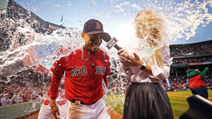 BOSTON, MASSACHUSETTS - SEPTEMBER 29: Mookie Betts #50 of the Boston Red Sox and NESN host Guerin Austin are doused in Gatorade after Betts scored the game winning run to defeat Baltimore Orioles 5-4 at Fenway Park on September 29, 2019 in Boston, Massachusetts. (Photo by Maddie Meyer/Getty Images)