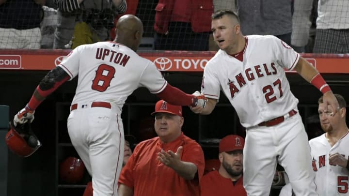 ANAHEIM, CA - SEPTEMBER 15: Justin Upton #8 of the Los Angeles Angels of Anaheim is congratulated by Mike Trout #27 of the Los Angeles Angels of Anaheim hitting a home run against the Seattle Mariners in the fourth inning at Angel Stadium on September 15, 2018 in Anaheim, California. (Photo by John McCoy/Getty Images)