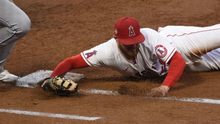 Los Angeles Angels first baseman Jared Walsh (20) dives to first to force out Kansas City Royals shortstop Nicky Lopez (8). Mandatory Credit: Kelvin Kuo-USA TODAY Sports