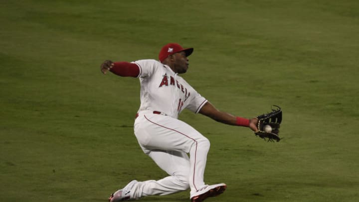 Los Angeles Angels left fielder Justin Upton (10) reaches to catch a ball hit by Kansas City Royals first baseman Carlos Santana (41). Mandatory Credit: Kelvin Kuo-USA TODAY Sports