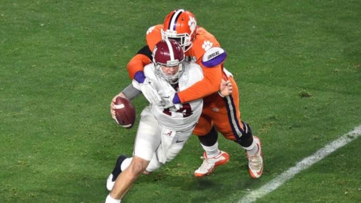 Jan 11, 2016; Glendale, AZ, USA; Alabama Crimson Tide quarterback Jake Coker (14) is brought down by Clemson Tigers defensive end Shaq Lawson (90) during the second quarter in the 2016 CFP National Championship at University of Phoenix Stadium. Mandatory Credit: Gary A. Vasquez-USA TODAY Sports