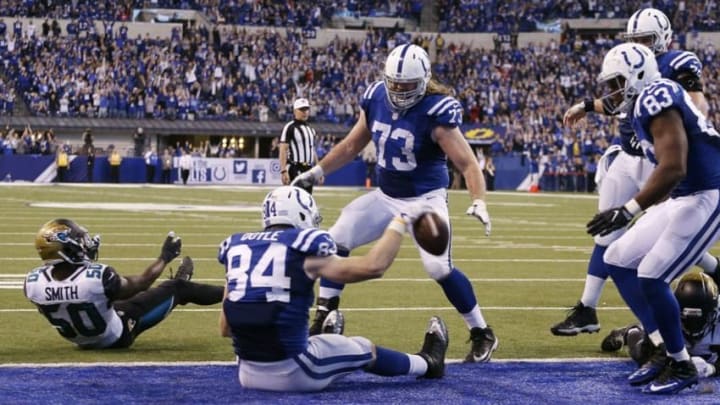 Jan 1, 2017; Indianapolis, IN, USA; Indianapolis Colts tight end Jack Doyle (84) spikes the ball after catching the winning touchdown in the end zone with under 15 seconds to go in the game against Jacksonville Jaguars cornerback Prince Amukamara (21) at Lucas Oil Stadium. Indianapolis defeats Jacksonville 24-20. Mandatory Credit: Brian Spurlock-USA TODAY Sports