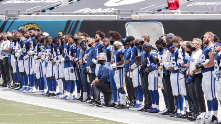JACKSONVILLE, FL - SEPTEMBER 13: Head Coach Frank Reich of the Indianapolis Colts takes a knee during the National Anthem with his team before the start of the game against the Jacksonville Jaguars at TIAA Bank Field on September 13, 2020 in Jacksonville, Florida. The Jaguars defeated the Colts 27 to 20. (Photo by Don Juan Moore/Getty Images)