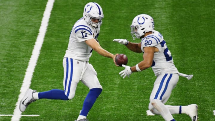DETROIT, MICHIGAN - NOVEMBER 01: Philip Rivers #17 of the Indianapolis Colts hands the ball off to Jordan Wilkins #20 during the fourth quarter at Ford Field on November 01, 2020 in Detroit, Michigan. (Photo by Nic Antaya/Getty Images)