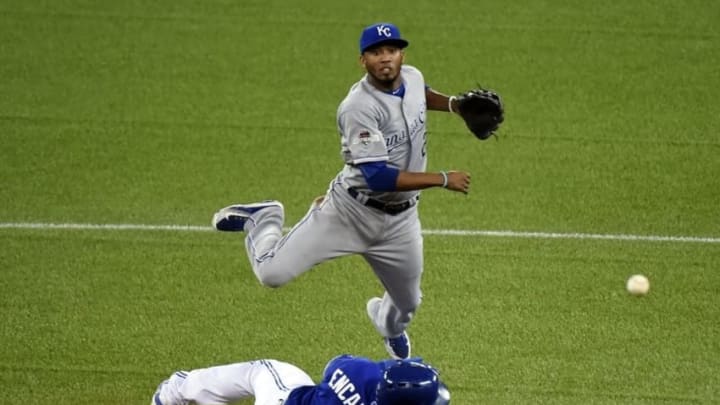 Oct 21, 2015; Toronto, Ontario, CAN; Kansas City Royals shortstop Alcides Escobar (2) completes a double play over Toronto Blue Jays designated hitter Edwin Encarnacion (10) during the fourth inning in game five of the ALCS at Rogers Centre. Mandatory Credit: Dan Hamilton-USA TODAY Sports