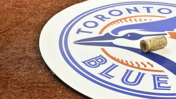 MONTREAL, QC - MARCH 26: A Toronto Blue Jays emblem is shown on the field against the Milwaukee Brewers during MLB spring training at Olympic Stadium on March 26, 2019 in Montreal, Quebec, Canada. The Toronto Blue Jays defeated the Milwaukee Brewers 2-0. (Photo by Minas Panagiotakis/Getty Images)