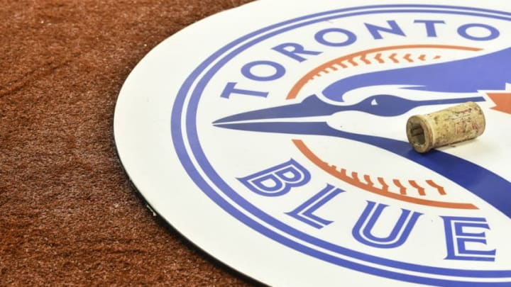 MONTREAL, QC - MARCH 26: A Toronto Blue Jays emblem is shown on the field against the Milwaukee Brewers during MLB spring training at Olympic Stadium on March 26, 2019 in Montreal, Quebec, Canada. The Toronto Blue Jays defeated the Milwaukee Brewers 2-0. (Photo by Minas Panagiotakis/Getty Images) MONTREAL, QC - MARCH 26: A Toronto Blue Jays emblem is shown on the field against the Milwaukee Brewers during MLB spring training at Olympic Stadium on March 26, 2019 in Montreal, Quebec, Canada. The Toronto Blue Jays defeated the Milwaukee Brewers 2-0. (Photo by Minas Panagiotakis/Getty Images)