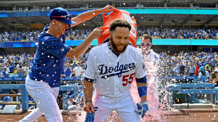 LOS ANGELES, CA - AUGUST 07: Russell Martin #55 is drenched with a cooler of ice water by Walker Buehler #21 and Joc Pederson #31 as they celebrate his two RBI single for a walk-off win against the St. Louis Cardinals in the ninth inning at Dodger Stadium on August 7, 2019 in Los Angeles, California. (Photo by Jayne Kamin-Oncea/Getty Images)
