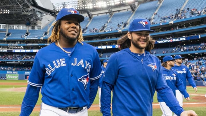 TORONTO, ONTARIO - SEPTEMBER 29: Vladimir Guerrero Jr. #27 and Bo Bichette #11 of the Toronto Blue Jays walk off the field after defeating the Tampa Bay Rays in the last game of the season in their MLB game at the Rogers Centre on September 29, 2019 in Toronto, Canada. (Photo by Mark Blinch/Getty Images)