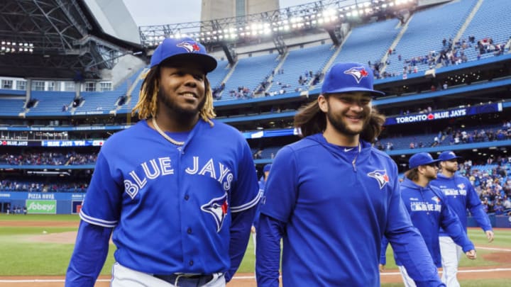 TORONTO, ONTARIO - SEPTEMBER 29: Vladimir Guerrero Jr. #27 and Bo Bichette #11 of the Toronto Blue Jays walk off the field after defeating the Tampa Bay Rays in the last game of the season in their MLB game at the Rogers Centre on September 29, 2019 in Toronto, Canada. (Photo by Mark Blinch/Getty Images)
