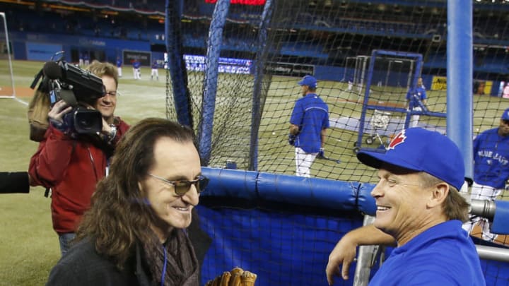 TORONTO, CANADA - APRIL 02: Rush singer Geddy Lee talks to manager John Gibbons #52 of the Toronto Blue Jays during batting practice before the start of MLB game action on Opening Day against the Cleveland Indians on April 2, 2013 at Rogers Centre in Toronto, Ontario, Canada. (Photo by Tom Szczerbowski/Getty Images)