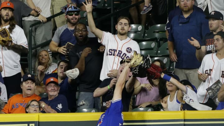 HOUSTON, TX - JUNE 25: Randal Grichuk #15 of the Toronto Blue Jays makes a leaping catch at the wall to take away a three run home run from George Springer #4 of the Houston Astros in the ninth inning at Minute Maid Park on June 25, 2018 in Houston, Texas. (Photo by Bob Levey/Getty Images)