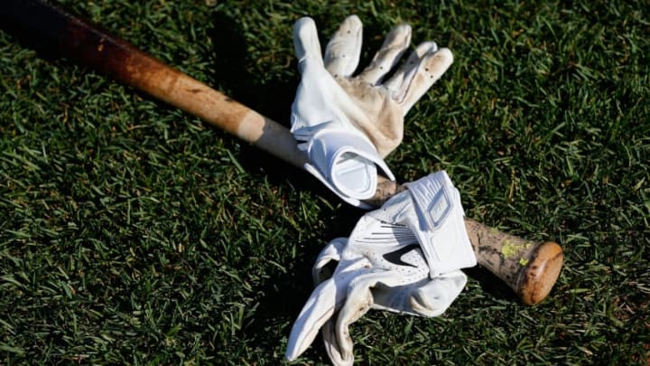 BALTIMORE, MD - APRIL 20: A bat and batting gloves sit on the grass before the start of the Toronto Blue Jays and Baltimore Orioles game at Oriole Park at Camden Yards on April 20, 2016 in Baltimore, Maryland. (Photo by Rob Carr/Getty Images)