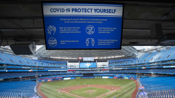 TORONTO, ON - JULY 09: A Covid-19 warning sign is seen over the diamond at Rogers Centre on July 9, 2020 in Toronto, Canada. (Photo by Mark Blinch/Getty Images)