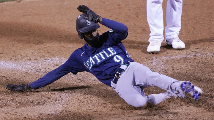 OAKLAND, CALIFORNIA – SEPTEMBER 25: Dee Strange-Gordon #9 of the Seattle Mariners scores on a passed ball against the Oakland Athletics in the top of the 10th inning at RingCentral Coliseum on September 25, 2020 in Oakland, California. (Photo by Thearon W. Henderson/Getty Images)