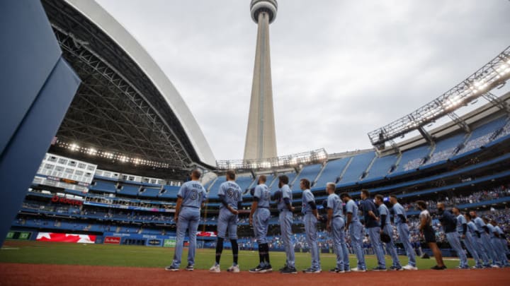 TORONTO, ON - JULY 31: Toronto Blue Jays players stand for the Canadian national anthem at the start of their MLB game against the Kansas City Royals at Rogers Centre on July 31, 2021 in Toronto, Ontario. (Photo by Cole Burston/Getty Images)