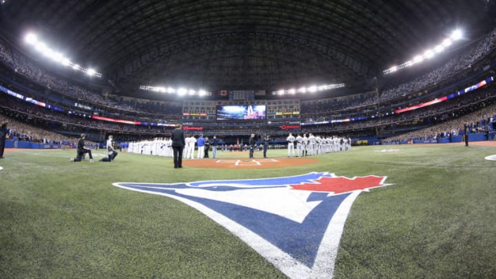 TORONTO, CANADA - APRIL 4: The lineups of the Toronto Blue Jays and New York Yankees stand for the playing of the anthems before the start of MLB game action on April 4, 2014 at Rogers Centre in Toronto, Ontario, Canada. (Photo by Tom Szczerbowski/Getty Images)