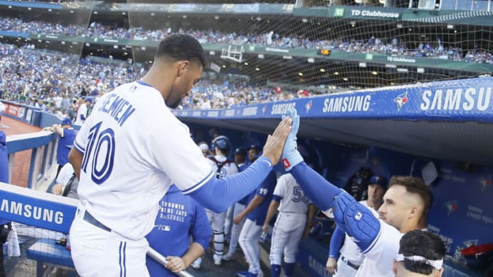 Sep 18, 2021; Toronto, Ontario, CAN; Toronto Blue Jays designated hitter George Springer (4) congratulates second baseman Marcus Semien (10) as he comes off the field against the Minnesota Twins in the eighth inning at Rogers Centre. Mandatory Credit: John E. Sokolowski-USA TODAY Sports