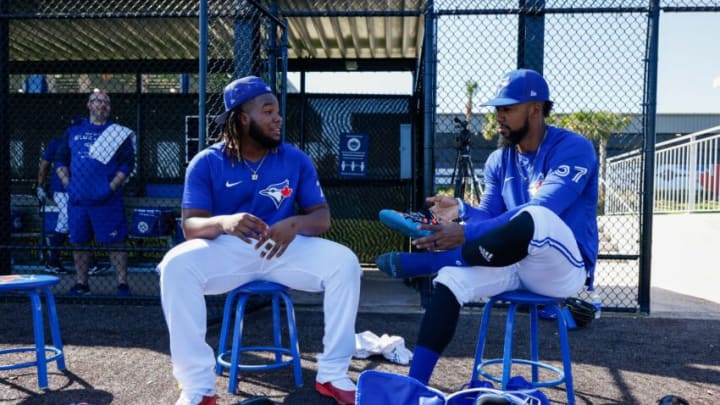 Mar 17, 2022; Dunedin, FL, USA; Toronto Blue Jays first baseman Vladimir Guerrero Jr. (27) and outfielder Teoscar Hernández (37) wait for batting practice to begin during workouts at Toronto Blue Jays Player Development Complex. Mandatory Credit: Nathan Ray Seebeck-USA TODAY Sports