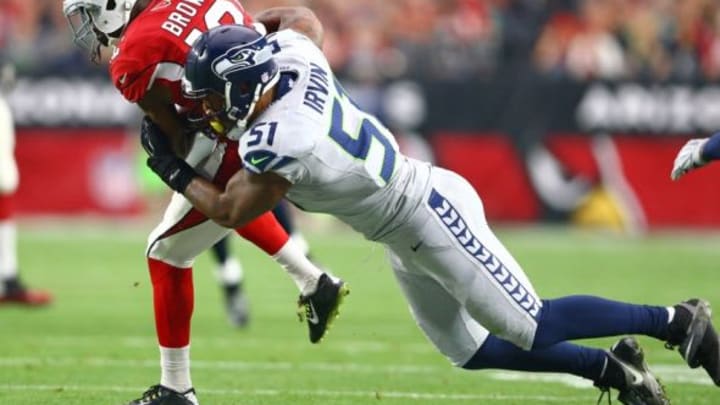 Jan 3, 2016; Glendale, AZ, USA; Seattle Seahawks linebacker Bruce Irvin (51) dives to tackle Arizona Cardinals wide receiver John Brown (12) in the first half at University of Phoenix Stadium. Mandatory Credit: Mark J. Rebilas-USA TODAY Sports