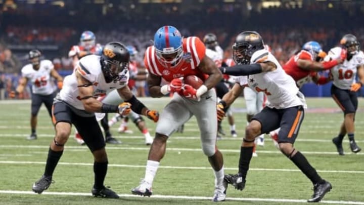 Jan 1, 2016; New Orleans, LA, USA; Mississippi Rebels wide receiver Laquon Treadwell (1) scores on a ten-yard catch past the defense by Oklahoma State Cowboys safety Jordan Sterns (13) and cornerback Kevin Peterson (1) in the second quarter of the 2016 Sugar Bowl at the Mercedes-Benz Superdome. Mandatory Credit: Chuck Cook-USA TODAY Sports