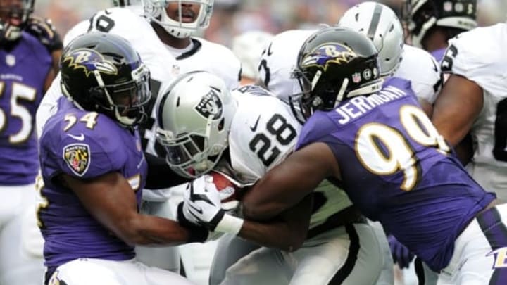Oct 2, 2016; Baltimore, MD, USA; Oakland Raiders running back Latavius Murray (28) is tackled by Baltimore Ravens linebacker Zachary Orr (54) and defensive tackle Timmy Jernigan (99) in the first quarter at M&T Bank Stadium. Mandatory Credit: Evan Habeeb-USA TODAY Sports