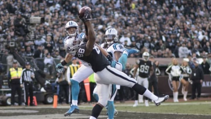 November 27, 2016; Oakland, CA, USA; Oakland Raiders tight end Clive Walford (88) catches a touchdown against Carolina Panthers outside linebacker A.J. Klein (56, left) and free safety Tre Boston (33, right) during the fourth quarter at Oakland Coliseum. The Raiders defeated the Panthers 35-32. Mandatory Credit: Kyle Terada-USA TODAY Sports