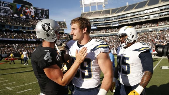 Oct 9, 2016; Oakland, CA, USA; Oakland Raiders quarterback Derek Carr (4) meets with San Diego Chargers defensive end Joey Bosa (99) after the game at Oakland Coliseum. The Raiders defeated the Chargers 34-31. Mandatory Credit: Cary Edmondson-USA TODAY Sports