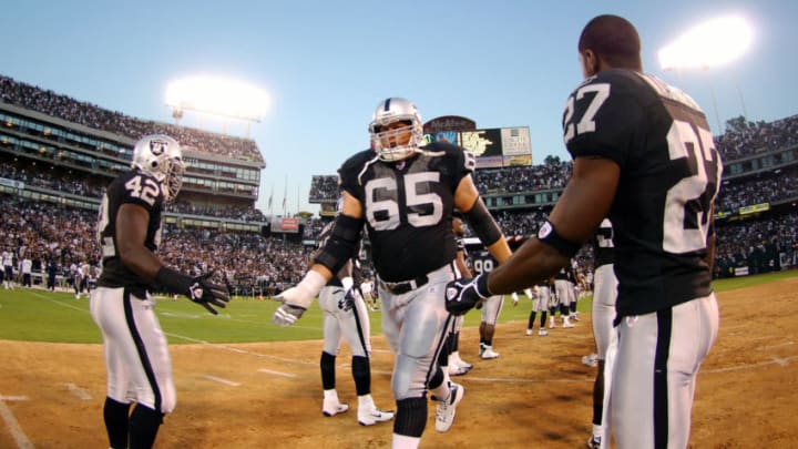 Oakland Raiders offensive guard Barry Sims is greeted by ReShard Lee (42) and Fabian Washington (27) during player introductions before ESPN Monday Night Football game at McAfee Coliseum on September 11, 2006. (Photo by Kirby Lee/NFLPhotoLibrary)