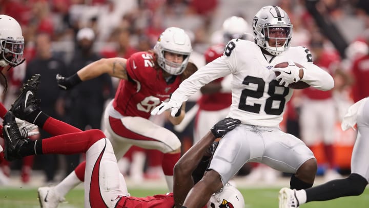 GLENDALE, ARIZONA – AUGUST 15: Running back Josh Jacobs #28 of the Oakland Raiders rushes the football past linebacker Chandler Jones #55 of the Arizona Cardinals during the first half of the NFL preseason game at State Farm Stadium on August 15, 2019 in Glendale, Arizona. (Photo by Christian Petersen/Getty Images)