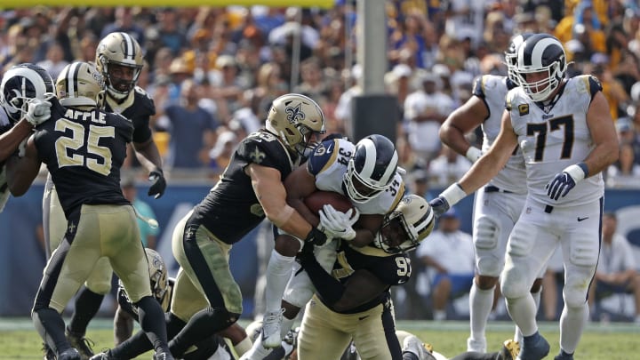 LOS ANGELES, CALIFORNIA – SEPTEMBER 15: Running back Malcolm Brown #34 of the Los Angeles Rams is tackled with the ball by outside linebacker A.J. Klein #53 and defensive end Mario Edwards #97 of the New Orleans Saints at Los Angeles Memorial Coliseum on September 15, 2019 in Los Angeles, California. (Photo by Meg Oliphant/Getty Images)