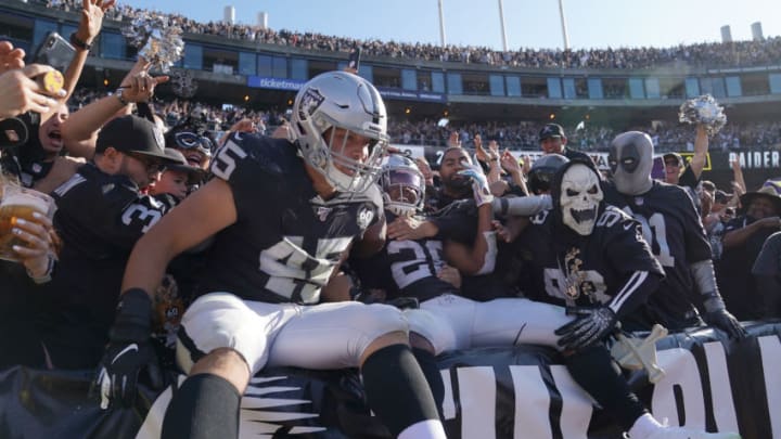 OAKLAND, CALIFORNIA - NOVEMBER 03: Josh Jacobs #28 and Alec Ingold #45 of the Oakland Raiders celebrates with fans in the "The Black Hole" after Jacobs scored on a two yard touchdown run against the Detroit Lions during the second quarter of an NFL football game at RingCentral Coliseum on November 03, 2019 in Oakland, California. (Photo by Thearon W. Henderson/Getty Images)