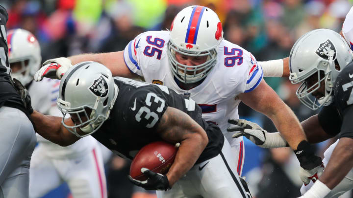 ORCHARD PARK, NY – OCTOBER 29: DeAndre Washington No. 33 of the Oakland Raiders runs the ball as Kyle Williams No. 95 of the Buffalo Bills attempts to tackle him during the third quarter of an NFL game on October 29, 2017 at New Era Field in Orchard Park, New York. (Photo by Brett Carlsen/Getty Images)