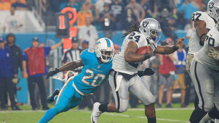 MIAMI GARDENS, FL – NOVEMBER 05: Running back Marshawn Lynch No. 24 of the Oakland Raiders is tackled by free safety Reshad Jones No. 20 of the Miami Dolphins at Hard Rock Stadium on November 5, 2017 in Miami Gardens, Florida. (Photo by Chris Trotman/Getty Images)