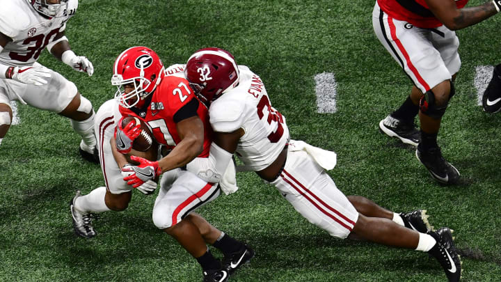 ATLANTA, GA – JANUARY 08: Nick Chubb #27 of the Georgia Bulldogs is tackled by Rashaan Evans #32 of the Alabama Crimson Tide in the CFP National Championship presented by AT&T at Mercedes-Benz Stadium on January 8, 2018 in Atlanta, Georgia. (Photo by Scott Cunningham/Getty Images)