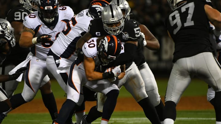 OAKLAND, CALIFORNIA – SEPTEMBER 09: Phillip Lindsay #30 of the Denver Broncos is tackled by Vontaze Burfict #55 of the Oakland Raiders during their NFL game at RingCentral Coliseum on September 09, 2019 in Oakland, California. (Photo by Robert Reiners/Getty Images)