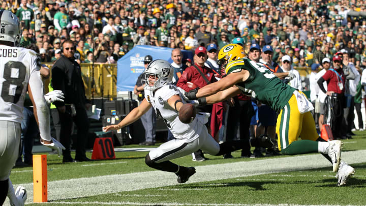GREEN BAY, WISCONSIN – OCTOBER 20: Derek Carr #4 of the Oakland Raiders fumbles the ball as he dives for the pylon during the second quarter in the game at Lambeau Field on October 20, 2019 in Green Bay, Wisconsin. (Photo by Dylan Buell/Getty Images)