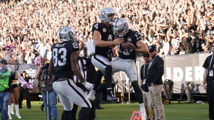 OAKLAND, CALIFORNIA - NOVEMBER 03: Hunter Renfrow #13 and Derek Carr #4 of the Oakland Raiders celebrates after Renfrow caught a touchdown pass from Carr against the Detroit Lions during the fourth quarter of an NFL football game at RingCentral Coliseum on November 03, 2019 in Oakland, California. The Raiders won the game 31-24. (Photo by Thearon W. Henderson/Getty Images)