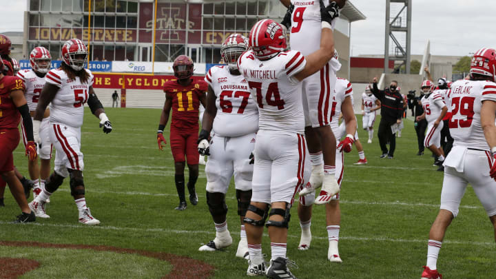 AMES, IA – SEPTEMBER 12: Running back Trey Ragas #9 of the Louisiana-Lafayette Ragin Cajuns is lifted into the air by teammate offensive lineman Max Mitchell #74 of the Louisiana-Lafayette Ragin Cajuns after he scored a touchdown in the second half of the play against the Iowa State Cyclones at Jack Trice Stadium on September 12, 2020, in Ames, Iowa. The Louisiana-Lafayette Ragin Cajuns won 31-14 over the Iowa State Cyclones. (Photo by David K Purdy/Getty Images)