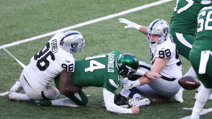 EAST RUTHERFORD, NEW JERSEY - DECEMBER 06: Sam Darnold #14 of the New York Jets fumbles after he is sacked by Clelin Ferrell #96 of the Las Vegas Raiders during the first half at MetLife Stadium on December 06, 2020 in East Rutherford, New Jersey. (Photo by Al Bello/Getty Images)