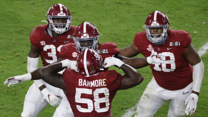 MIAMI GARDENS, FLORIDA - JANUARY 11: Christian Barmore #58 and Phidarian Mathis #48 of the Alabama Crimson Tide react during the fourth quarter of the College Football Playoff National Championship game against the Ohio State Buckeyes at Hard Rock Stadium on January 11, 2021 in Miami Gardens, Florida. (Photo by Michael Reaves/Getty Images)